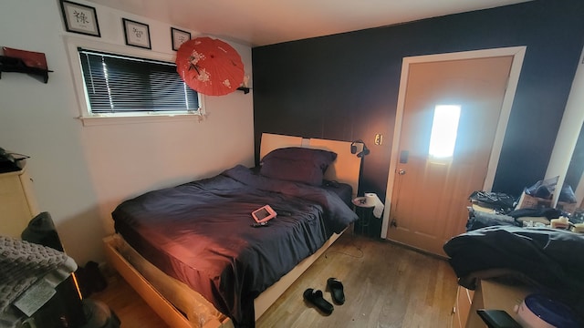 bedroom with hardwood / wood-style floors