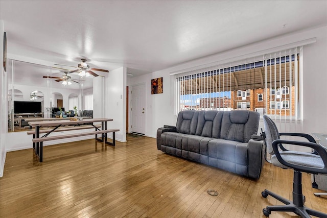 living room featuring ceiling fan, hardwood / wood-style flooring, and a healthy amount of sunlight