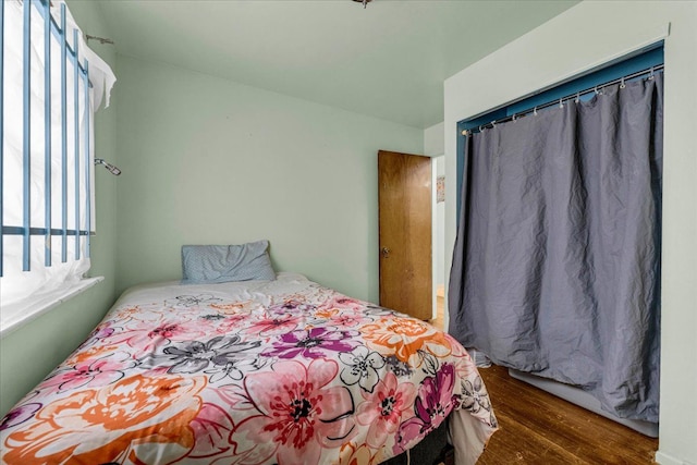 bedroom with dark hardwood / wood-style flooring