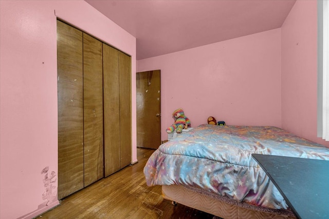 bedroom with a closet and light hardwood / wood-style flooring