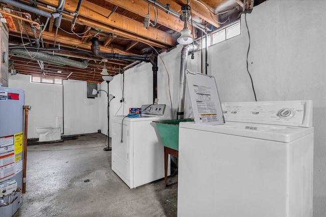 clothes washing area featuring separate washer and dryer, gas water heater, and electric panel