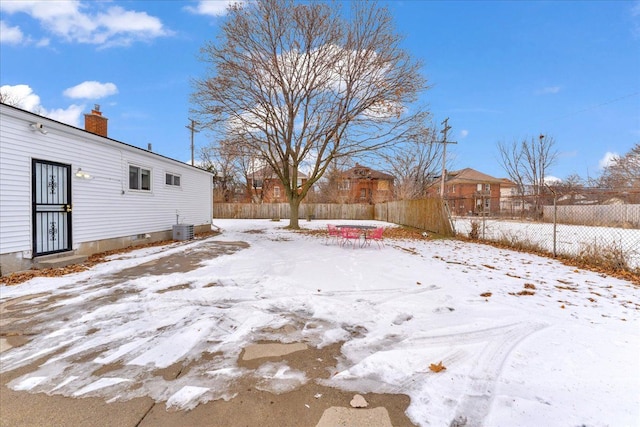 view of yard layered in snow