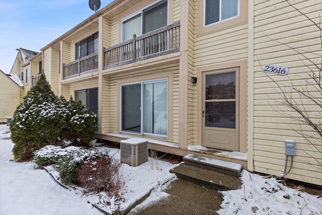 view of snow covered property entrance