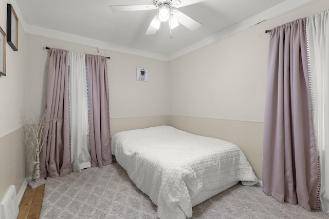 bedroom featuring crown molding, ceiling fan, and light hardwood / wood-style flooring