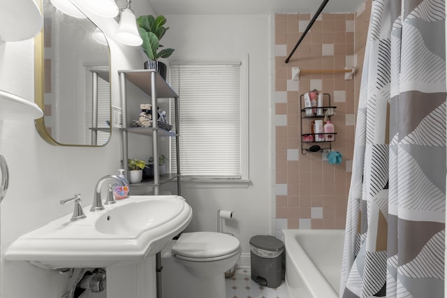 full bathroom with sink, shower / bath combination with curtain, and toilet