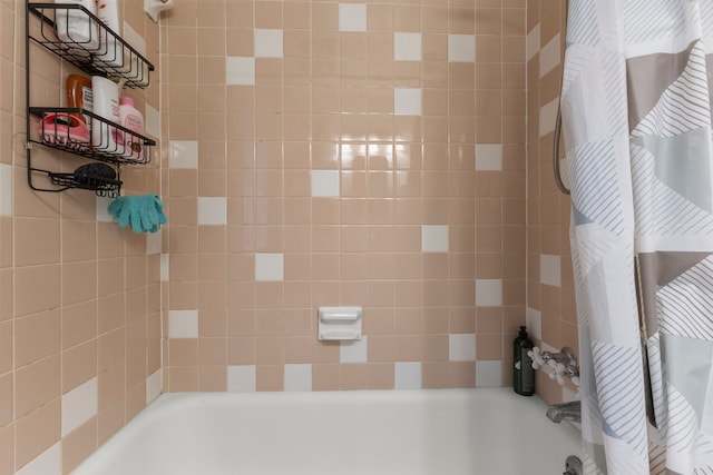 bathroom featuring shower / tub combo and radiator