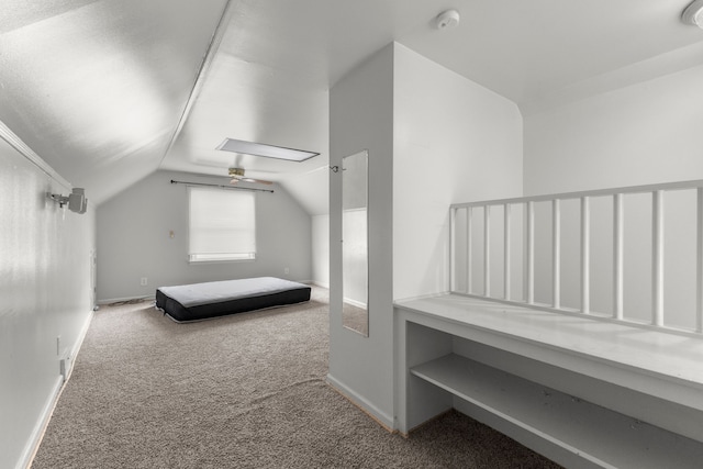 unfurnished bedroom with carpet and lofted ceiling