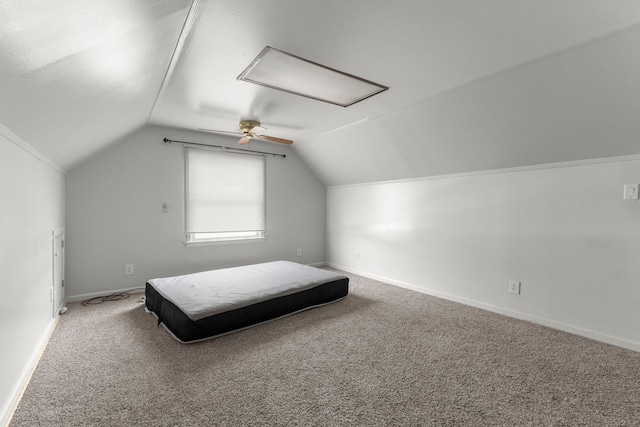 unfurnished bedroom featuring carpet floors, ceiling fan, and vaulted ceiling