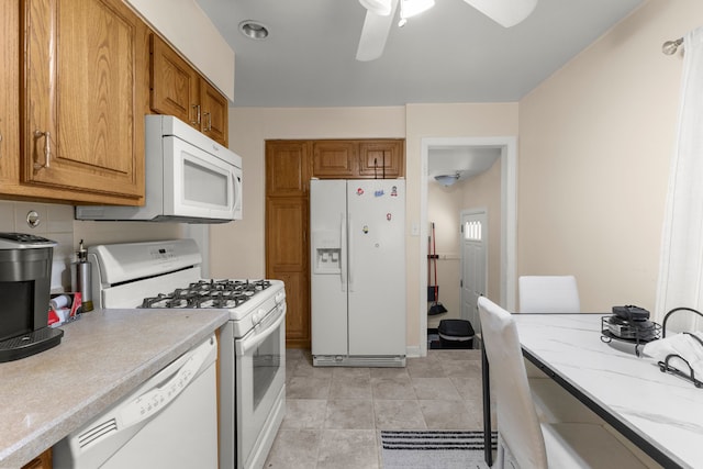 kitchen with ceiling fan, white appliances, decorative backsplash, and light tile patterned floors