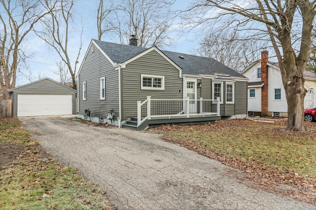 view of front facade with a garage, an outbuilding, and a front lawn