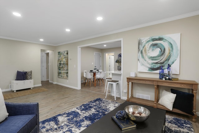 living room with ornamental molding and hardwood / wood-style floors