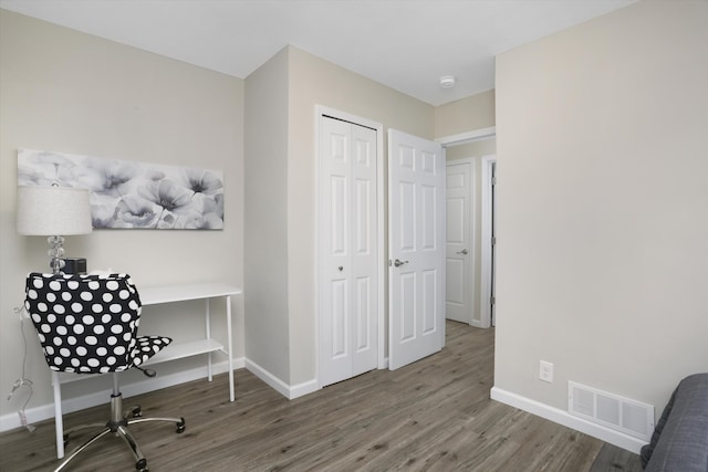 office space with wood-type flooring