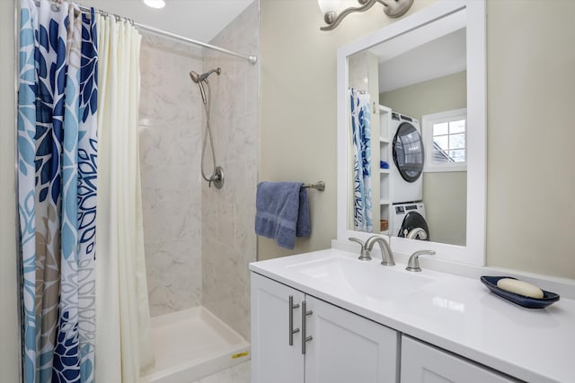 bathroom with walk in shower, stacked washer and clothes dryer, and vanity