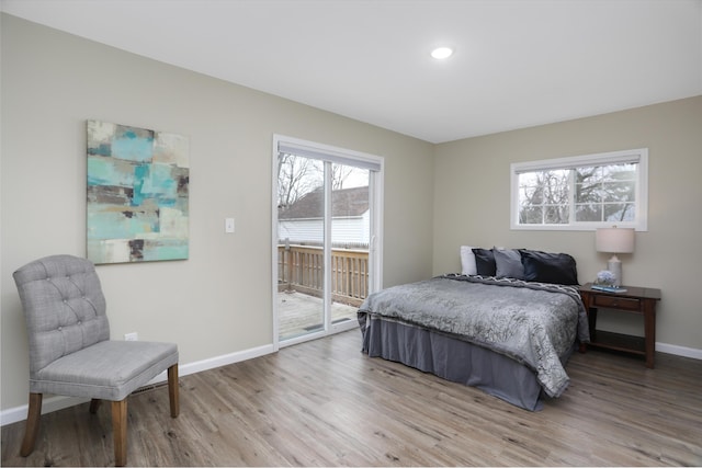 bedroom featuring light wood-type flooring and access to outside