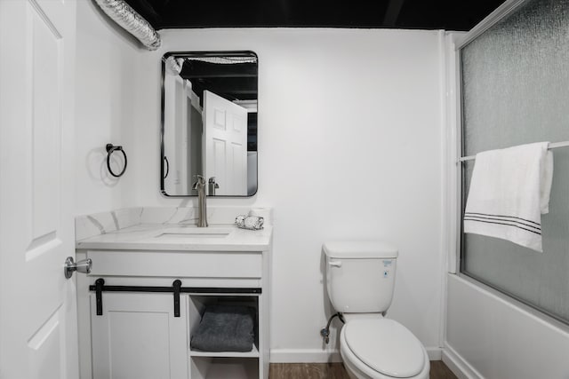 full bathroom with vanity, wood-type flooring, enclosed tub / shower combo, and toilet