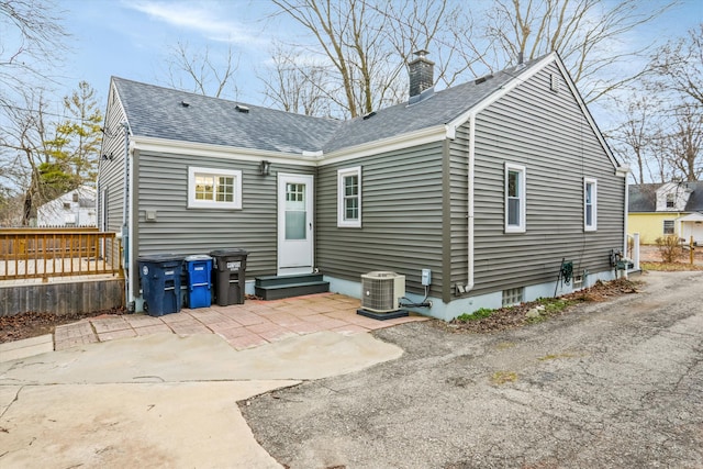 back of house featuring a patio area and central air condition unit