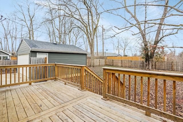 wooden deck featuring an outbuilding and a garage