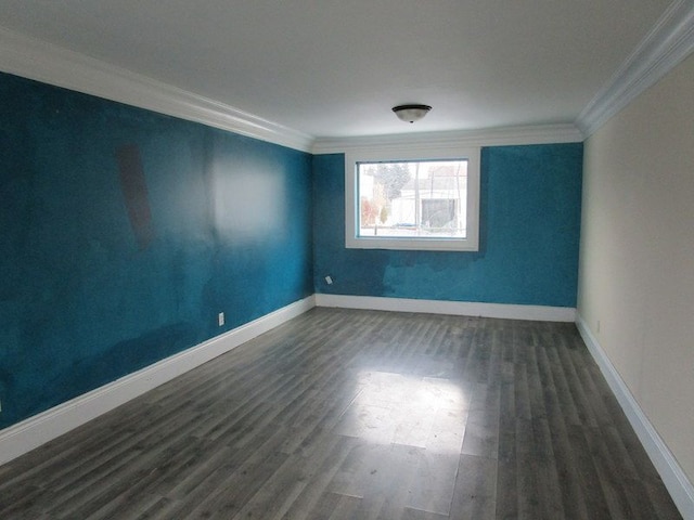 spare room with dark hardwood / wood-style flooring and crown molding