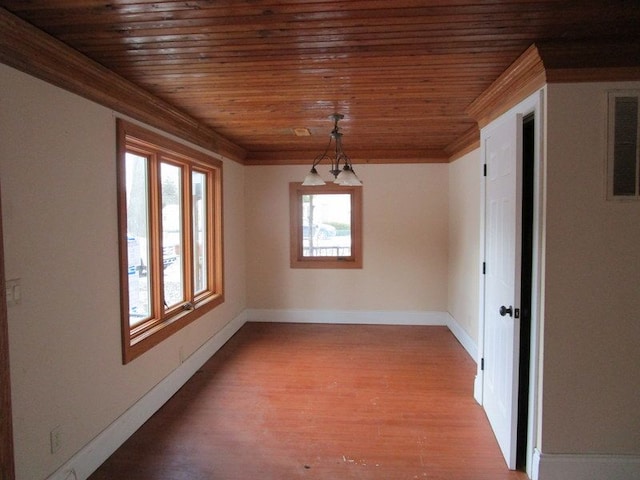 unfurnished dining area with ornamental molding, plenty of natural light, light hardwood / wood-style floors, and wooden ceiling