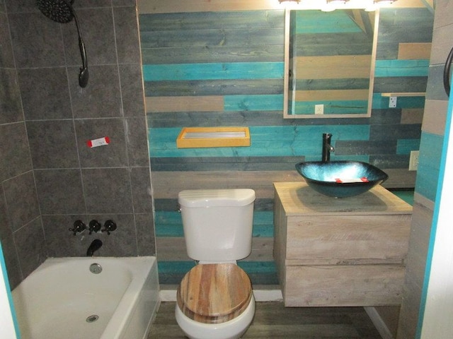 full bathroom with vanity, tiled shower / bath combo, and toilet