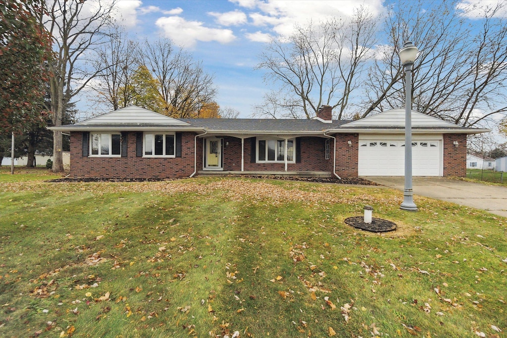 ranch-style house with a garage and a front lawn