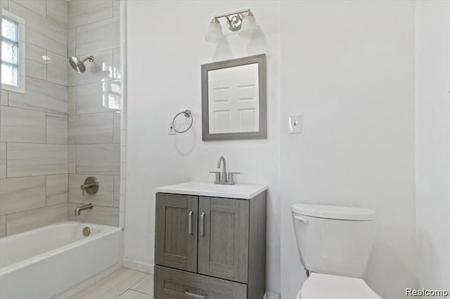 full bathroom with tiled shower / bath combo, vanity, and toilet