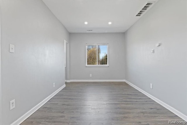 spare room featuring dark wood-type flooring