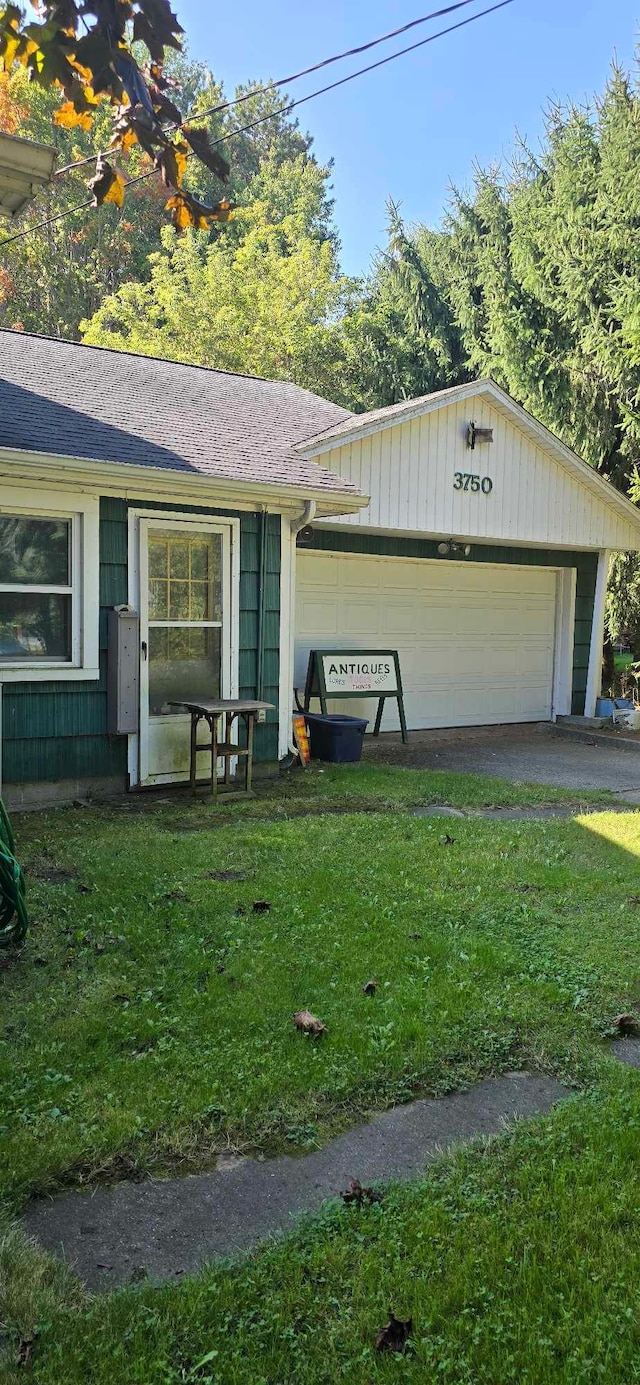 exterior space with a garage and a front yard