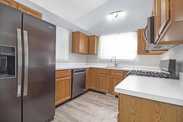 kitchen with sink, light hardwood / wood-style flooring, and appliances with stainless steel finishes