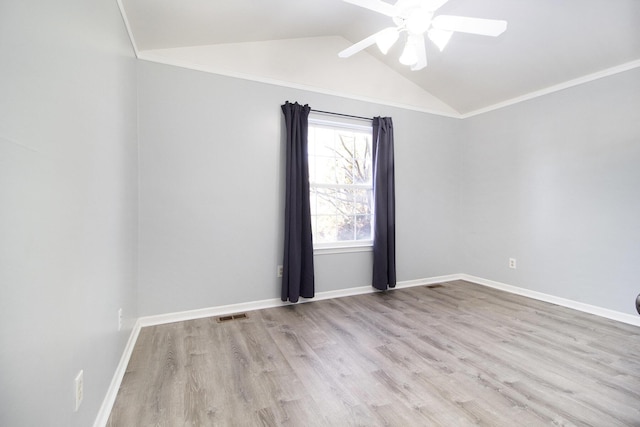 spare room with ceiling fan, ornamental molding, vaulted ceiling, and light hardwood / wood-style flooring