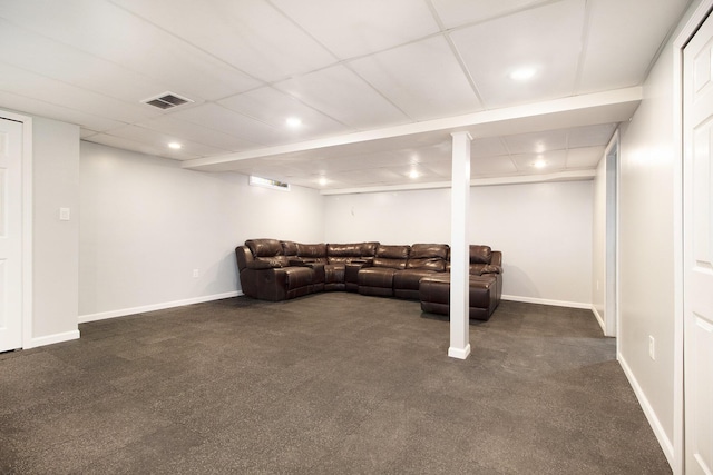 living room featuring a paneled ceiling and dark colored carpet