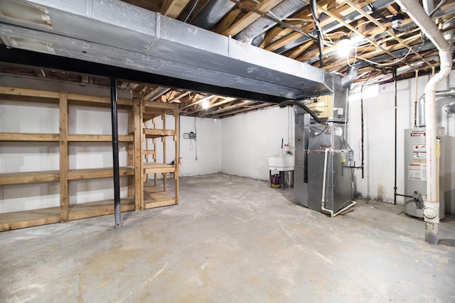 basement with heating unit, sink, and water heater