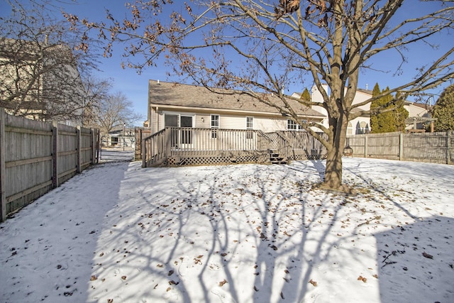 snow covered property featuring a deck