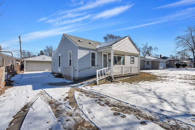 view of front of house with an outbuilding, a porch, and a garage