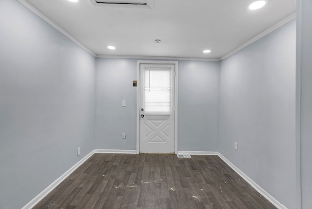 doorway with ornamental molding and dark hardwood / wood-style flooring