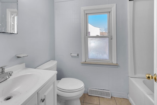 bathroom featuring tile patterned flooring, vanity, and toilet