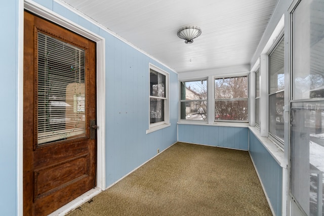 626 Orange St, Jackson, MI 49202 - unfurnished sunroom with carpet floors, wooden walls, and ornamental molding
