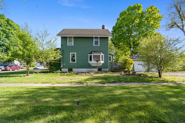 626 Orange St, Jackson, MI 49202 - view of front of home with a chimney and a front yard