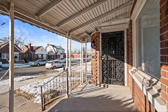 snow covered patio with covered porch