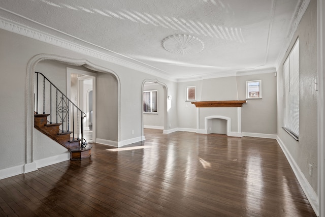 unfurnished living room featuring dark hardwood / wood-style floors and a textured ceiling