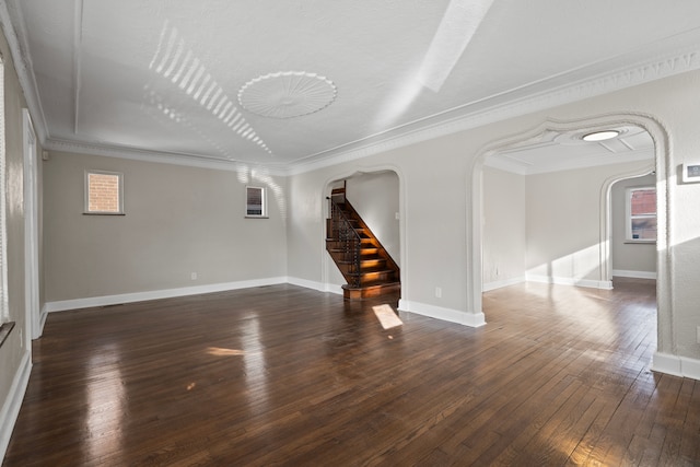 unfurnished room featuring dark wood-type flooring and ornamental molding