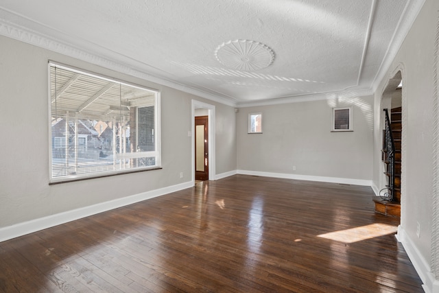 unfurnished living room featuring ornamental molding, dark hardwood / wood-style floors, and a textured ceiling