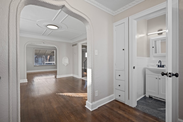 hallway featuring ornamental molding, dark hardwood / wood-style floors, and sink