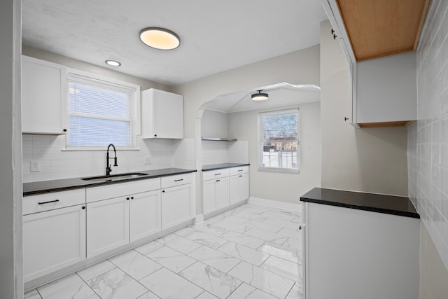 kitchen featuring sink, a wealth of natural light, and white cabinets