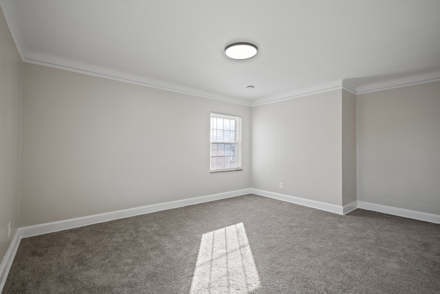 unfurnished room featuring dark colored carpet and ornamental molding