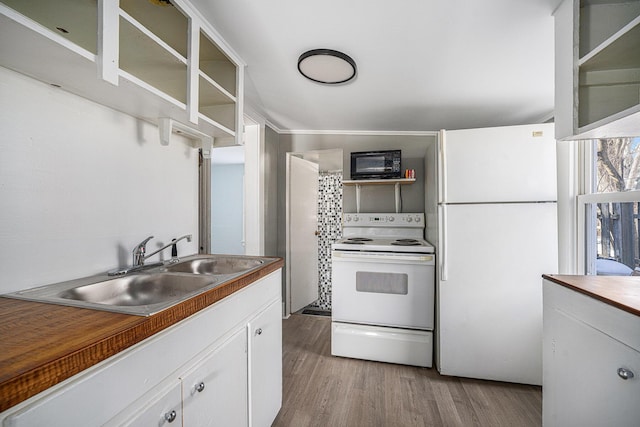 kitchen featuring white appliances, light hardwood / wood-style floors, sink, and white cabinets