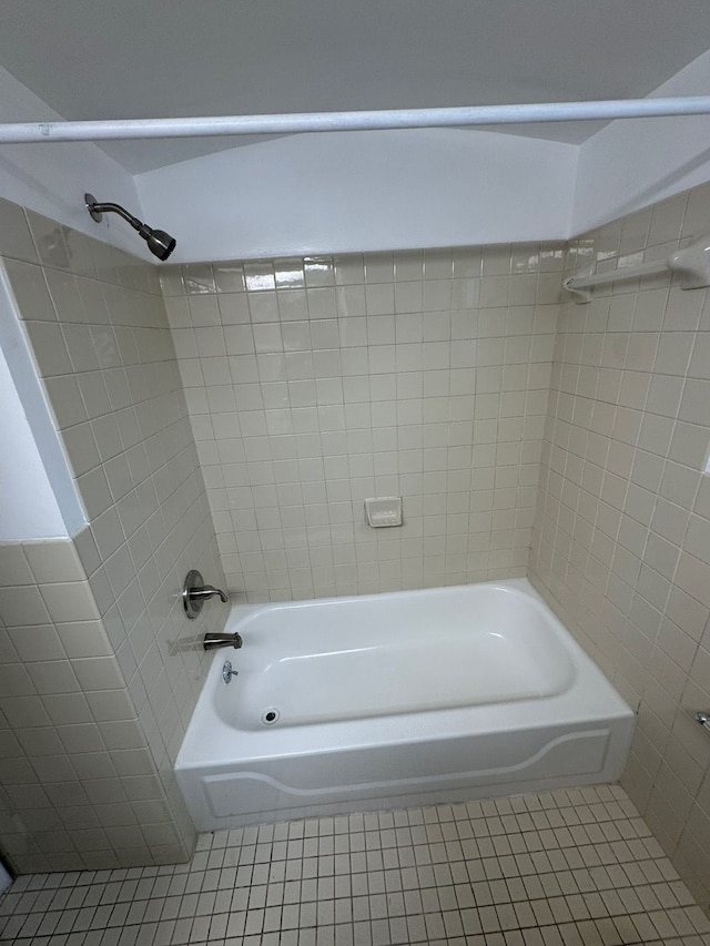 bathroom with tiled shower / bath combo and tile patterned floors