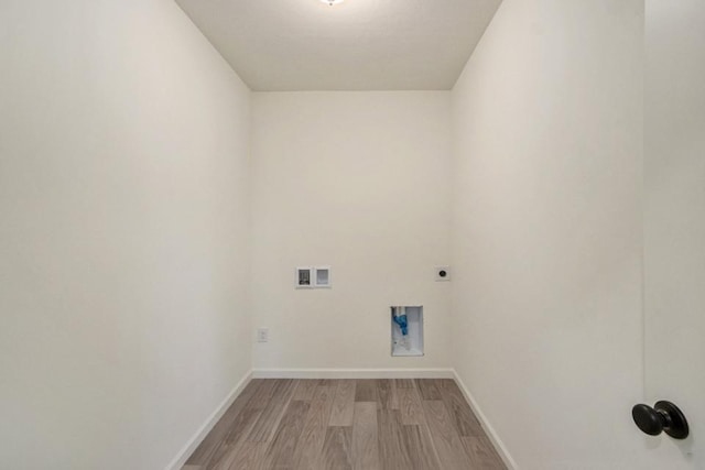 clothes washing area featuring laundry area, baseboards, light wood-style flooring, hookup for a washing machine, and electric dryer hookup