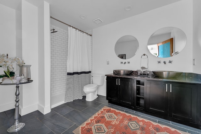 bathroom with vanity, tile patterned floors, toilet, and walk in shower