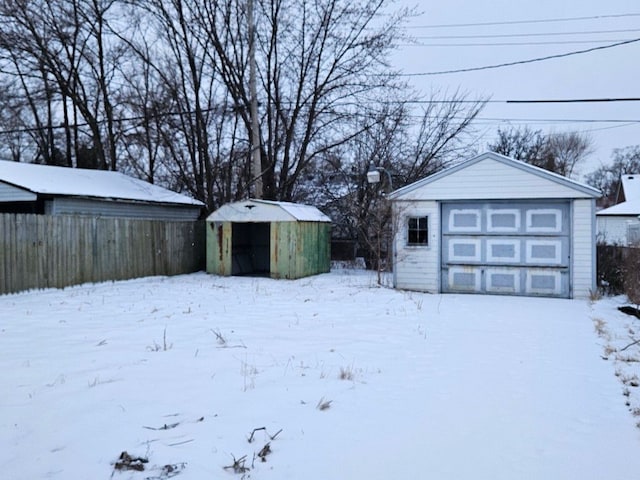 yard covered in snow featuring a storage shed